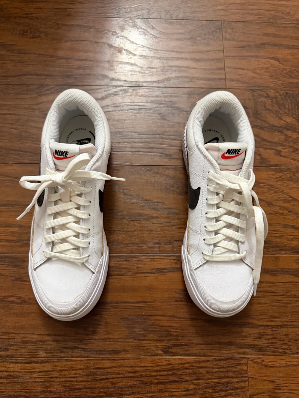 Nike Women’s White Low-Top Sneakers with Black Swoosh